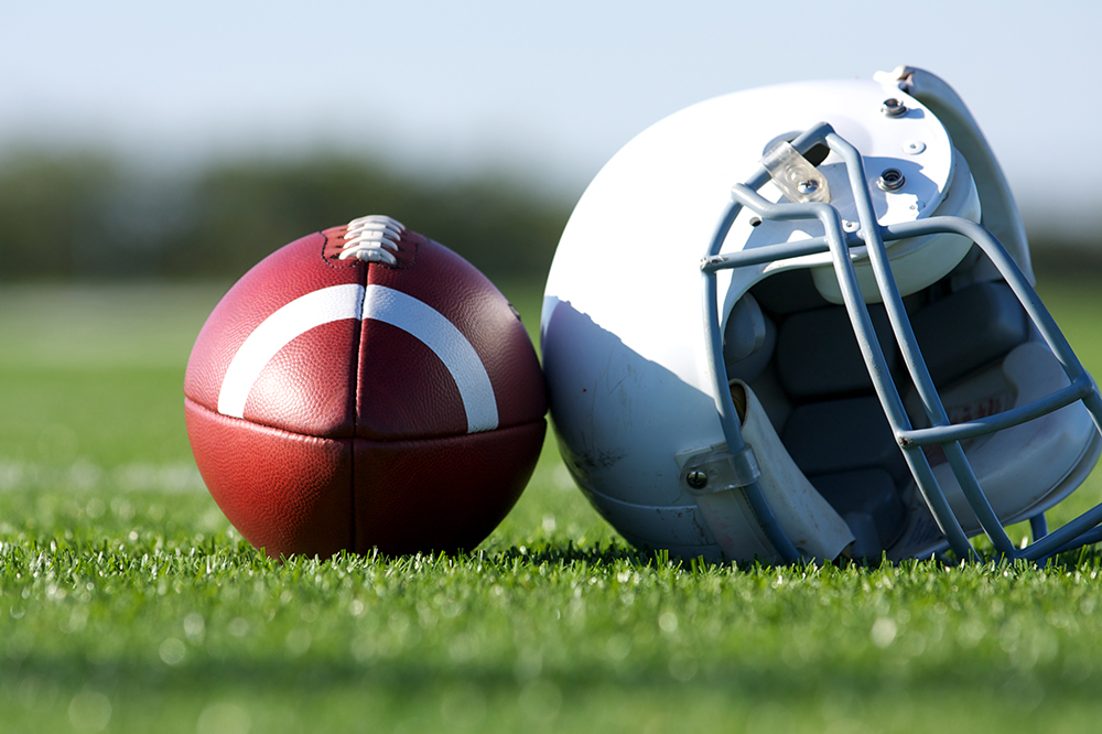 American Football and Helmet on the Field